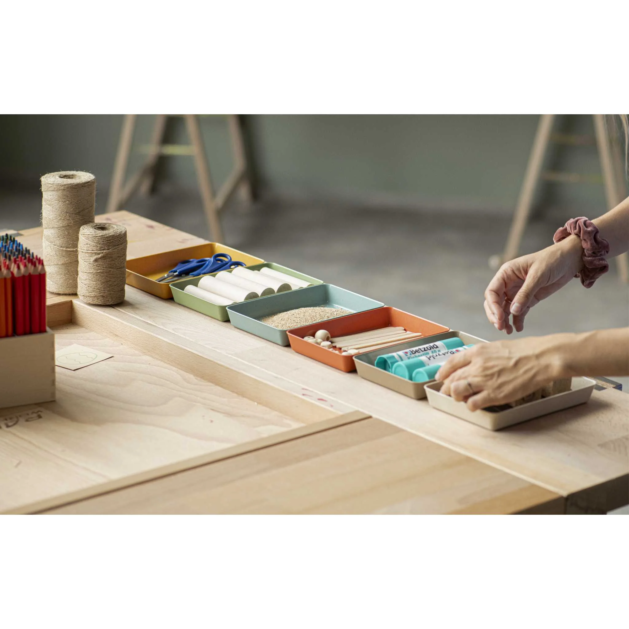 Crafting table, Spools of twine, Glue sticks, Colored pencils, Workshop tools