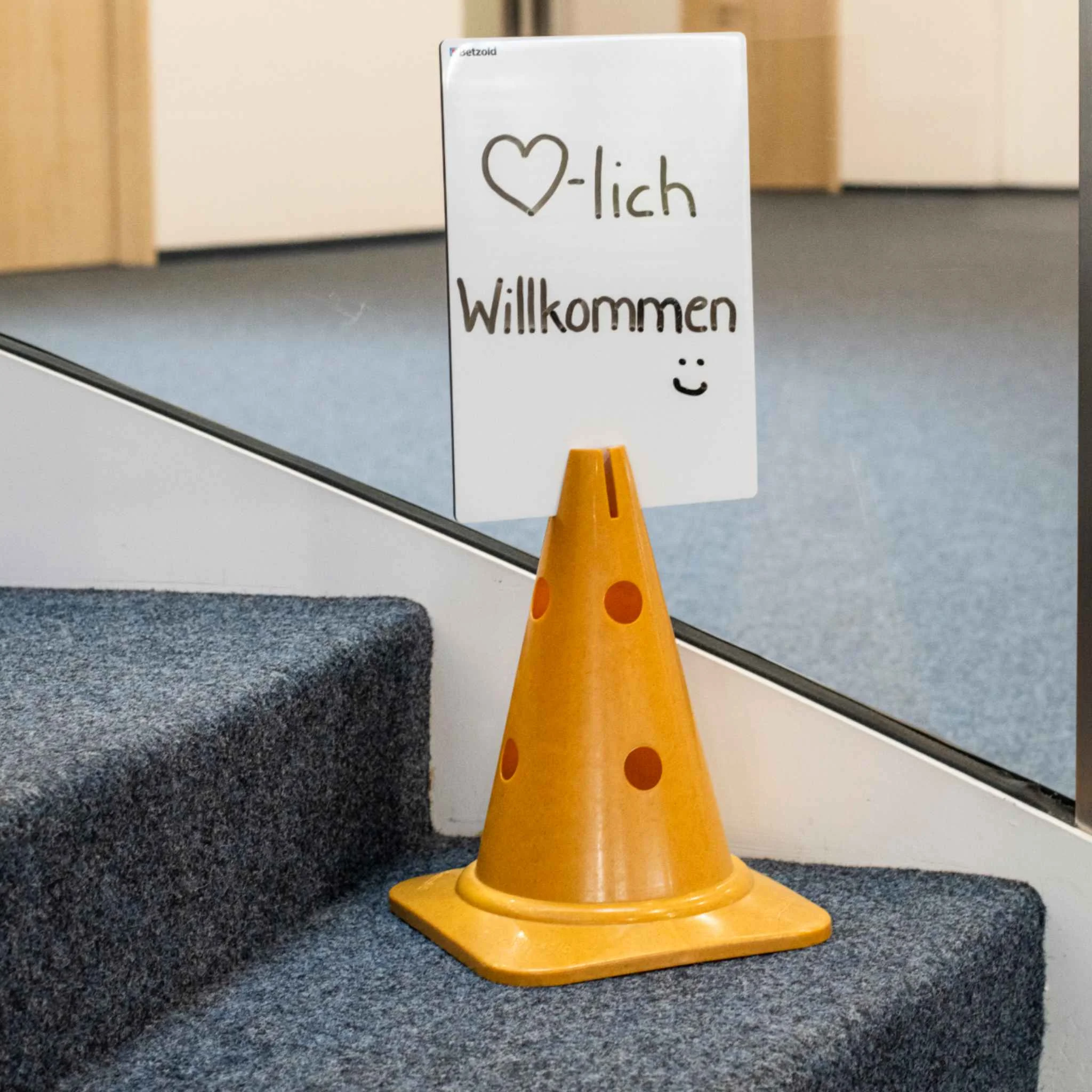 orange cone, traffic cone, cone, floor marker, stair area sign