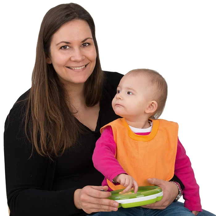 baby, mom, orange bib, pink sweater, green tray