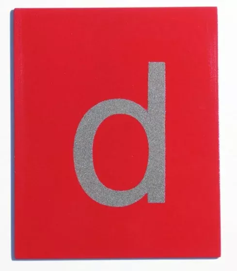 red cover, book, glossy, patterned, letter d