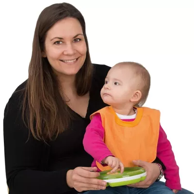 baby, mom, orange bib, pink sweater, green tray